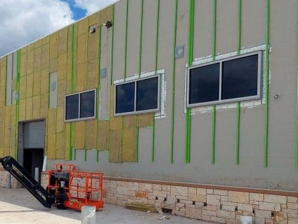 GreenGirt Max CMH vertical Z-girts and mineral wool insulation partially finished on an exterior wall at the Tom Lester Jr. CTE Center.